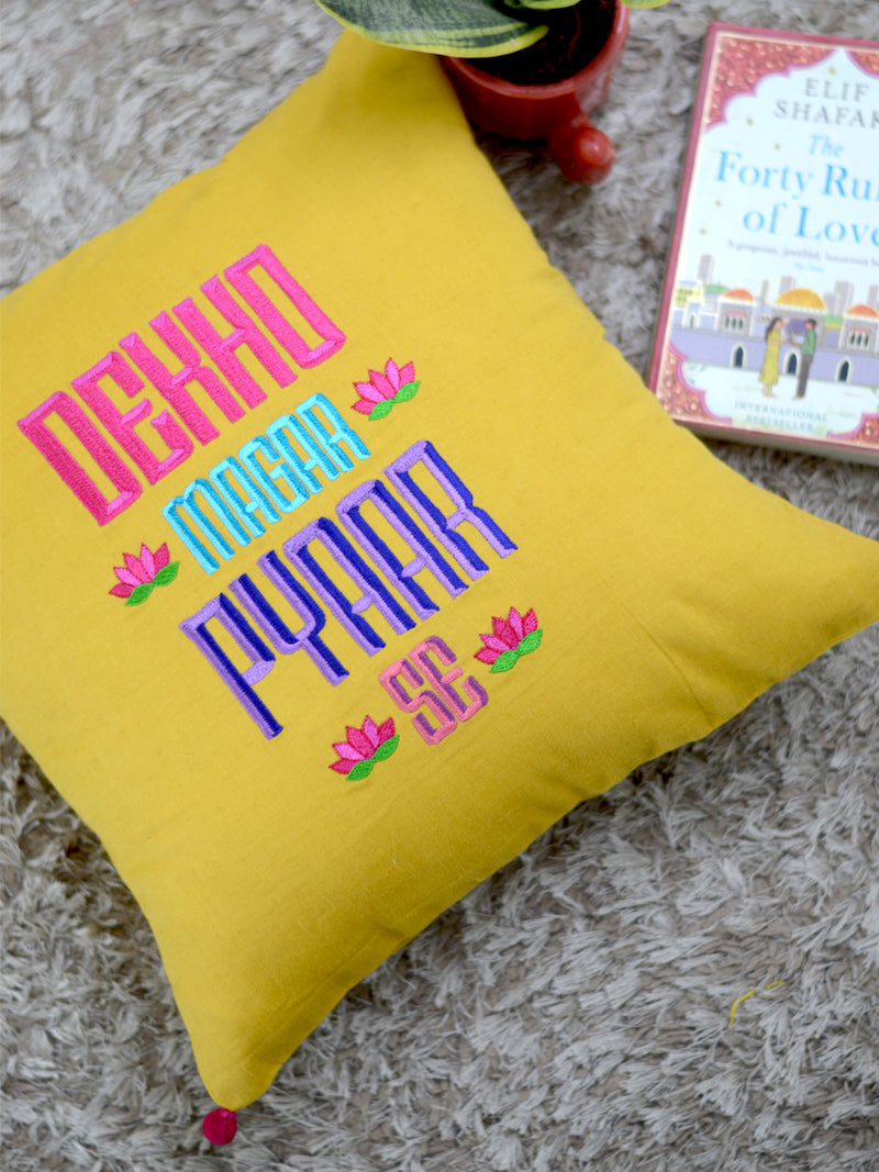 Dekho Magar Pyaar Se Cushion Cover, a hand embroidered cotton cushion cover with pom pom detailing from our wide range of quirky, bohemian home decor products like ethnic cushion covers, thread art, wall decor and more.