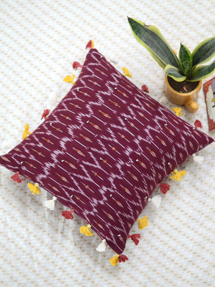 Prosperity Cushion Cover (Maroon), a unique hand embroidered cotton cushion cover with soundless ghungroo and tassel detailing from our wide range of quirky, bohemian home decor products like ethnic cushion covers, thread art, wall decor and more.